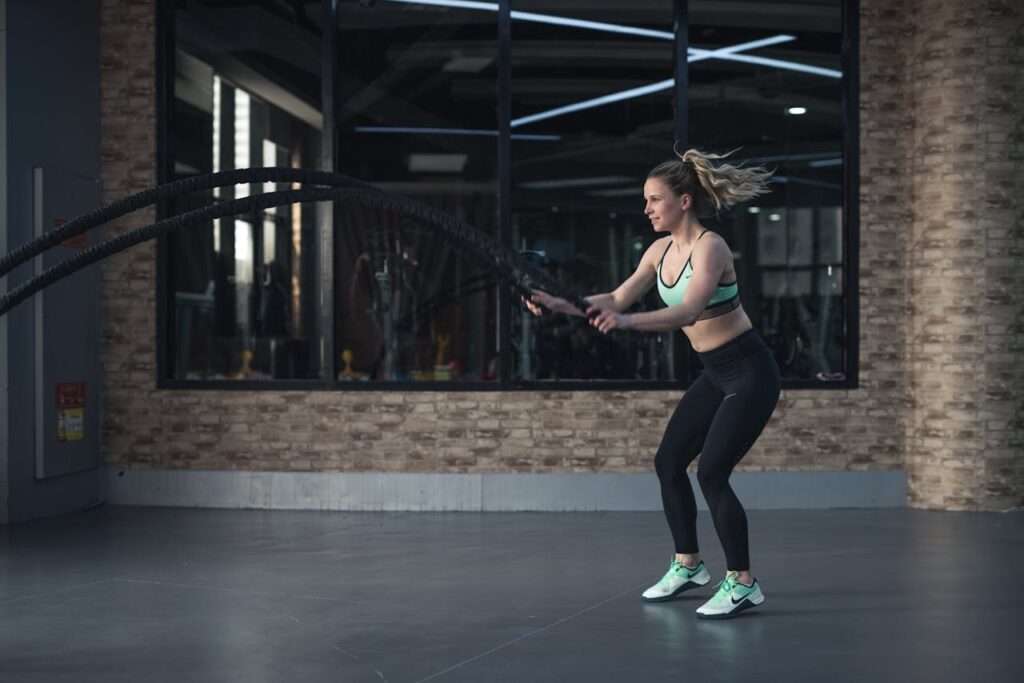 pexels photo 2294400 Focused woman performing CrossFit rope training indoors, demonstrating strength and endurance.
